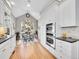 Eat in kitchen boasts stainless double oven, white cabinetry and gleaming hardwood floors and eat in kitchen table at 8312 S Peninsula Dr, Littleton, CO 80120