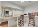 Functional laundry room featuring a sink, workspace, overhead shelving, and seating at 8312 S Peninsula Dr, Littleton, CO 80120