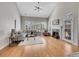Spacious living room with high ceilings, hardwood floors, fireplace, and large windows at 8312 S Peninsula Dr, Littleton, CO 80120