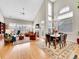 Spacious living room with tall windows, fireplace, hardwood flooring and elegant chandelier at 8312 S Peninsula Dr, Littleton, CO 80120