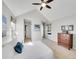 Bright main bedroom with ceiling fan, large windows, comfortable bed and beautiful furnishings at 8312 S Peninsula Dr, Littleton, CO 80120