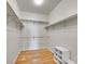 Spacious walk-in closet with hardwood floors, custom shelving, and ample storage space at 8312 S Peninsula Dr, Littleton, CO 80120