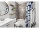 Bathroom with shower/tub, decorative shelves, modern fixtures and tiled walls at 11225 W 102Nd Pl, Westminster, CO 80021
