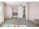 Bedroom with grey carpet, closet with shelving and clothes and a doorway into another room at 11225 W 102Nd Pl, Westminster, CO 80021