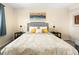 Cozy bedroom featuring a large bed with decorative pillows, two side tables, and modern wall art at 11225 W 102Nd Pl, Westminster, CO 80021