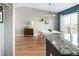 Dining room featuring hardwood floors, modern lighting, gray walls, and sliding glass doors at 11225 W 102Nd Pl, Westminster, CO 80021