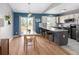 Bright kitchen featuring a center island, wood floors, modern appliances, and ample natural light at 11225 W 102Nd Pl, Westminster, CO 80021
