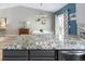 Bright kitchen with gray cabinetry, granite countertops, stainless steel appliances, and eat-in dining area at 11225 W 102Nd Pl, Westminster, CO 80021
