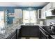 Modern kitchen with granite countertops, stylish backsplash, and stainless steel appliances at 11225 W 102Nd Pl, Westminster, CO 80021