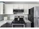 Contemporary kitchen with granite counters, modern appliances, and stylish backsplash at 11225 W 102Nd Pl, Westminster, CO 80021