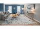 Bright living room featuring a gray sofa, accent chair, modern decor, and a stylish rug on light hardwood floors at 11225 W 102Nd Pl, Westminster, CO 80021