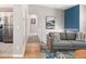 Open-concept living area boasts hardwood floors, a comfortable gray sofa, and stylish decor, creating an inviting space at 11225 W 102Nd Pl, Westminster, CO 80021