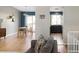 Open concept: living and dining spaces with hardwood floors, modern lighting, and neutral decor at 11225 W 102Nd Pl, Westminster, CO 80021
