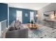 Cozy living room with a comfortable gray sofa, stylish patterned rug, and bright windows with plantation shutters at 11225 W 102Nd Pl, Westminster, CO 80021
