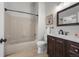 Bright bathroom featuring a tiled shower, framed art and neutral tones at 4899 S Dudley St # 19, Littleton, CO 80123