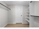 A walk in closet with white walls, trim and adjustable shelving at 4899 S Dudley St # 19, Littleton, CO 80123