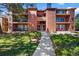 Well-maintained apartment building with brick accents and lush landscaping at 4899 S Dudley St # 19, Littleton, CO 80123