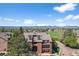 Scenic exterior view highlighting the building's design, balconies, and expansive green space with mountain backdrop at 4899 S Dudley St # 19, Littleton, CO 80123