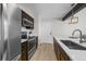 Modern kitchen with dark wood cabinets and stainless steel appliances at 4899 S Dudley St # 19, Littleton, CO 80123