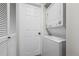 A stacked washer and dryer set with white cabinets and trim at 4899 S Dudley St # 19, Littleton, CO 80123