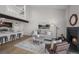 Open living space with a fireplace, kitchen bar, and loft above at 4899 S Dudley St # 19, Littleton, CO 80123