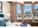 Cozy bedroom showcases a great view through three windows at 1616 14Th St # 4E, Denver, CO 80202