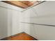 Walk-in closet includes two silver racks for clothing and hardwood floors at 1616 14Th St # 4E, Denver, CO 80202