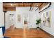 Hallway with hardwood floors and an open doorway leading to a bathroom with wooden vanity at 1616 14Th St # 4E, Denver, CO 80202