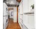 Efficient laundry area featuring modern, stacked washer and dryer and functional shelving for storage at 1616 14Th St # 4E, Denver, CO 80202