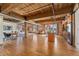 Expansive living room with hardwood floors, exposed ceiling beams, kitchen and office space at 1616 14Th St # 4E, Denver, CO 80202