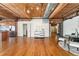 Open-concept living space boasts hardwood floors, exposed ductwork, modern decor, and a stainless steel kitchen at 1616 14Th St # 4E, Denver, CO 80202