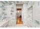 Modern tiled shower with a built in seat and hardwood floors visible through the glass door at 1616 14Th St # 4E, Denver, CO 80202