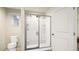 Clean bathroom featuring a glass-enclosed shower, toilet, and ample lighting at 46529 Sunflower Ln, Bennett, CO 80102