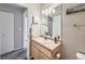 Well-lit bathroom features a vanity with a light wood cabinet and a clean, white countertop and sink at 8481 W Union Ave # 4-203, Littleton, CO 80123