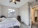 Bright bedroom with a ceiling fan and a view of the neighborhood, offering comfort and convenience at 8481 W Union Ave # 4-203, Littleton, CO 80123