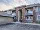 Exterior view of an apartment building, showing garages, units, and stairways at 8481 W Union Ave # 4-203, Littleton, CO 80123