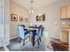 Cozy dining area featuring a dark wood table and comfortable blue chairs at 8481 W Union Ave # 4-203, Littleton, CO 80123