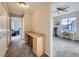 Hallway desk area connects to a bedroom with an exercise bike and outdoor views at 8481 W Union Ave # 4-203, Littleton, CO 80123