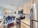 View of kitchen with wood cabinets connecting to the dining area at 8481 W Union Ave # 4-203, Littleton, CO 80123