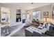 Well-lit living room featuring a fireplace, built-in shelving, and modern furnishings at 8481 W Union Ave # 4-203, Littleton, CO 80123