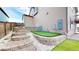 Landscaped backyard with putting green and stone retaining walls at 9183 Pitkin St, Commerce City, CO 80022