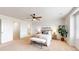 Main bedroom with ceiling fan, carpet flooring, and ensuite bathroom at 9183 Pitkin St, Commerce City, CO 80022