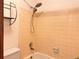 Bathroom with a shower and tub combo with tiled walls and a handheld shower head at 912 S Dearborn Way # 15, Aurora, CO 80012