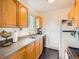 This kitchen has stainless steel appliances, light wood cabinets, and gray countertops at 10625 Moore Ct, Broomfield, CO 80021