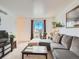 Inviting living room with plush sofa, coffee table, and window with natural light at 10625 Moore Ct, Broomfield, CO 80021