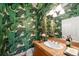 This bathroom features a unique botanical wallpaper design with sink and mirror above a wooden vanity at 581 Garfield St, Denver, CO 80206
