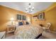 Bright bedroom with yellow walls, white furniture, and elegant chandelier lighting at 581 Garfield St, Denver, CO 80206