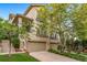 Inviting home with a stone-clad facade, a well-manicured lawn, and a spacious two-car garage at 581 Garfield St, Denver, CO 80206