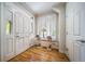 Bright foyer with hardwood floors, stylish table, and a window with plantation shutters for a welcoming entrance at 581 Garfield St, Denver, CO 80206