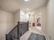 Bright hallway leading to rooms with glass doors, carpet flooring, and a decorative rug enhancing the home's interior at 581 Garfield St, Denver, CO 80206